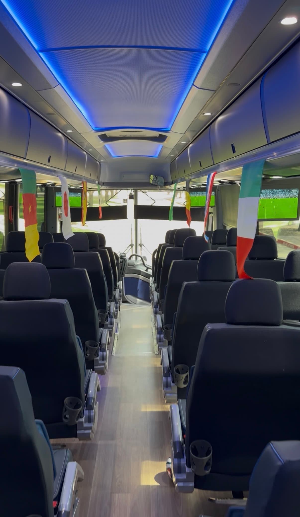 Inside a RYDWAY coach looking forward, Dallas Stadium visible through the windshield